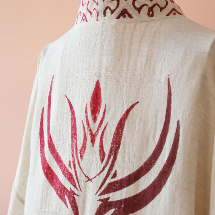 linen kimono has hand-made, red prints at the back